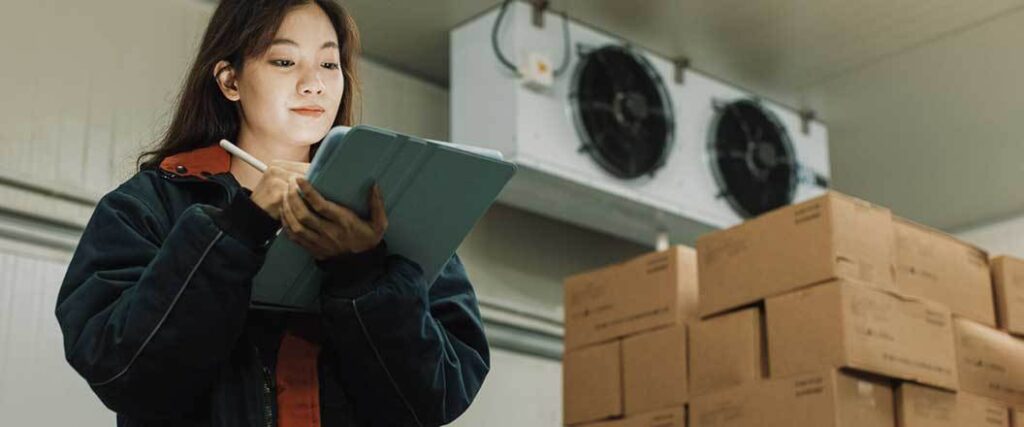 A warehouse worker taking inventory of perishable goods