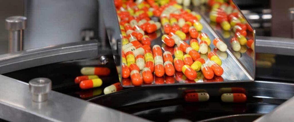 Close of image of pills going through a sorting machine